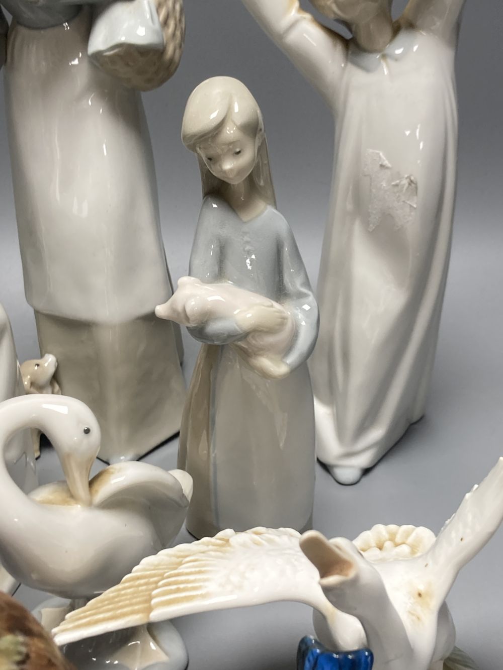 A collection of Lladro and Goebel porcelain figures and other items